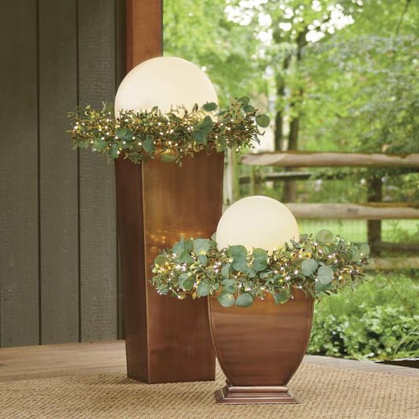ElementLamp lampada portatile a sfera ricaricabile per interni ed esterni: due sfere accese su un pavimento in legno tra fioriere - Luximode