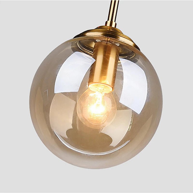 LumiSfera – lampada a sospensione in vetro e metallo dorato di Luximode