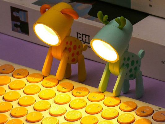 Due mini lampade WoofBuddy a forma di cerbiatto accese sulla tastiera